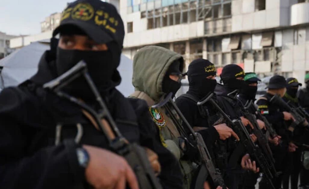 Hamas fighters stand guard in Gaza after the group announces dissolution of its governing body.
