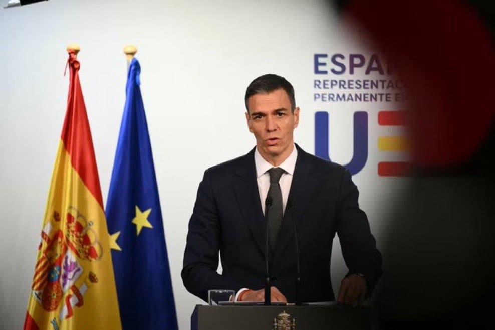 Pedro Sanchez speaks beside Spain and EU flags as Spain's immigration regularisation scheme draws over 1.17 million applications.