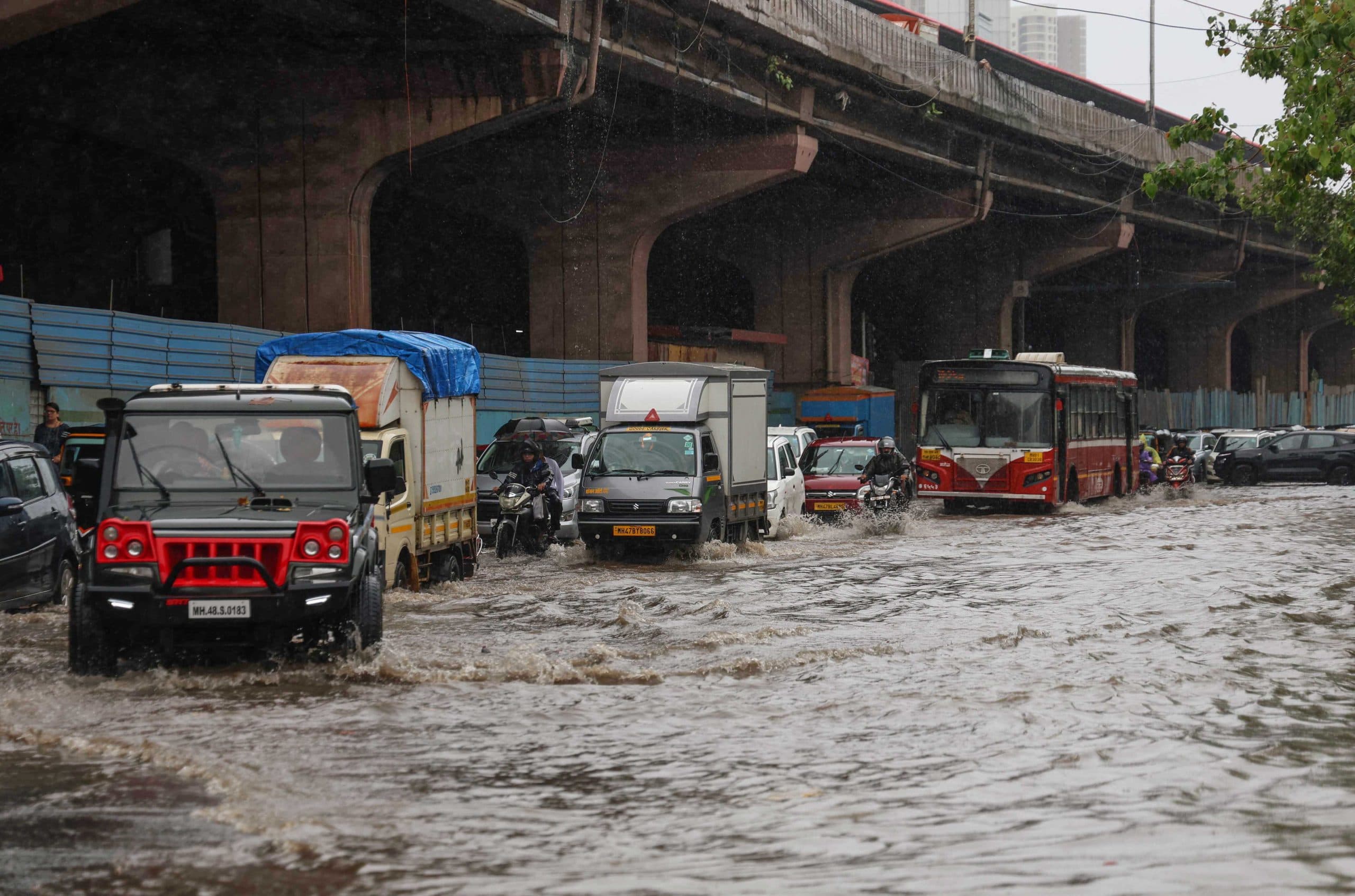 Vehicles wade through a waterlogged road at Andheri West, in Mumbai on Friday.