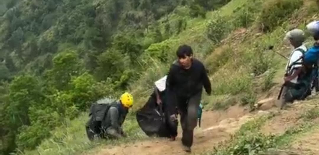 Young boy during a paragliding takeoff attempt.