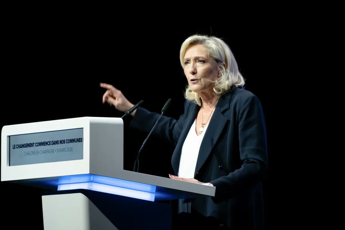 Marine Le Pen speaks into a handheld microphone during a public appearance ahead of a key appeal court ruling in France.