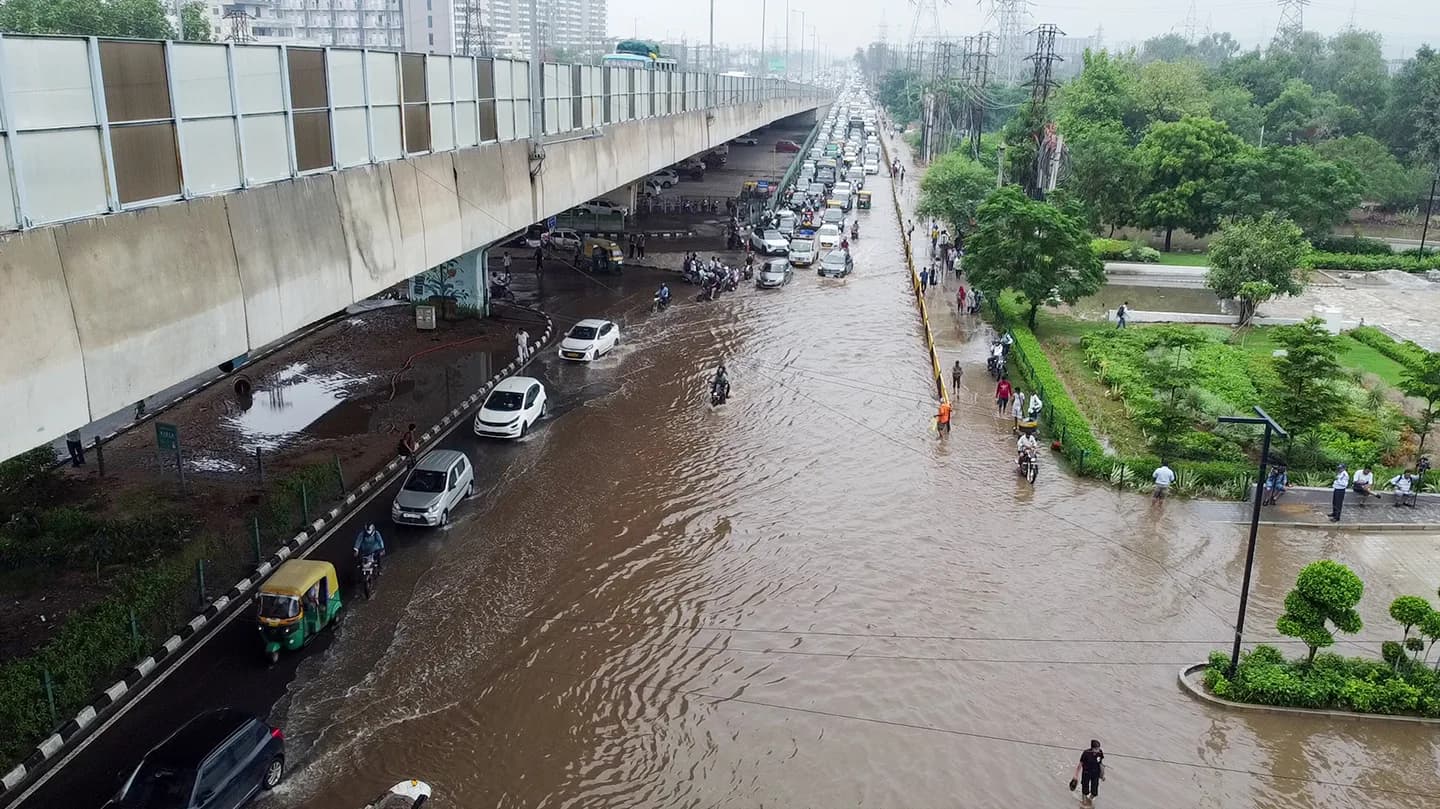 Gurugram, Jul 08 (ANI): A drone visual of the vehicles wading through a waterlogged area on Sohna Road, caused by heavy rainfall, in Gurugram on Wednesday. (ANI Video Grab)