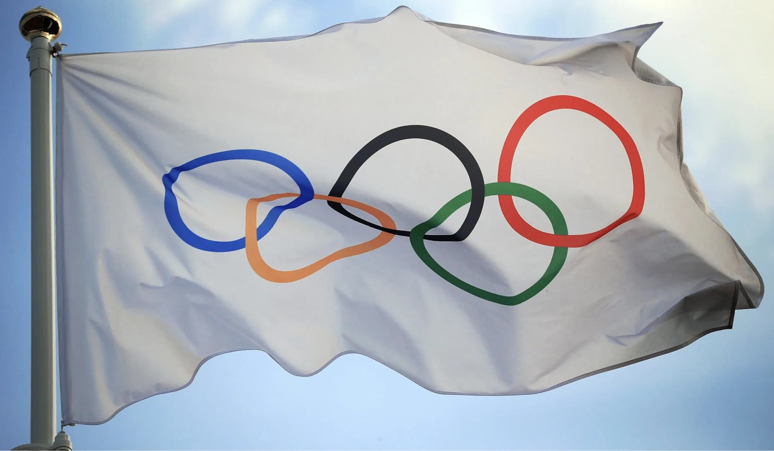 Olympic flag with the five rings fluttering as the IOC eases Russia's path toward a potential full return for the 2028 Los Angeles Olympics.