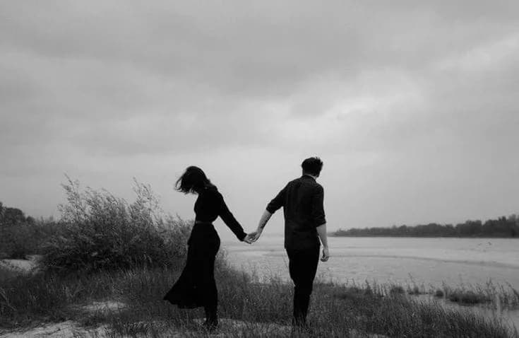 A couple sitting apart in silence, highlighting emotional distance despite good intentions in marriage.