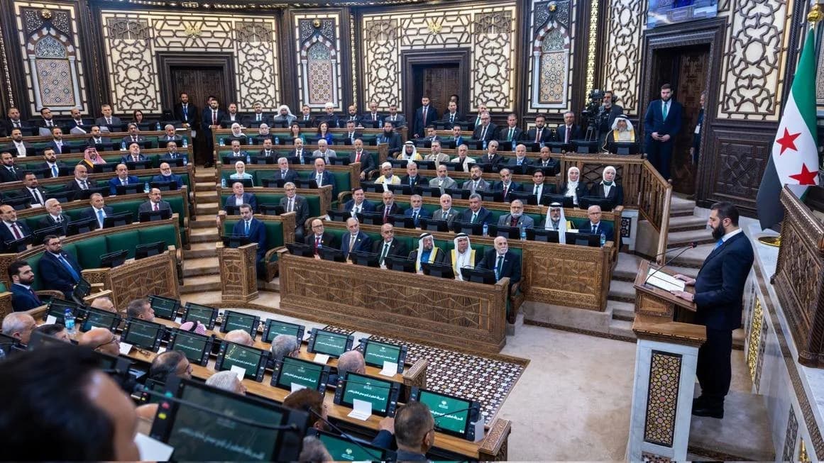 Lawmakers attend the first session of Syria's new parliament in Damascus.