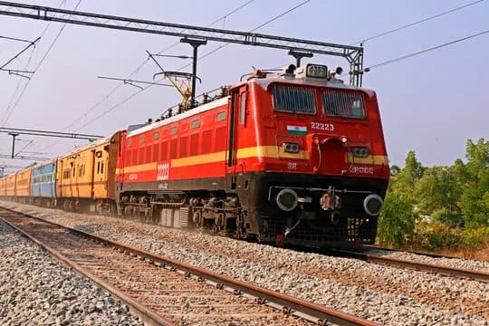 The redesigned IRCTC ticket booking website displayed on a laptop, highlighting new features such as faster bookings, fare calendar and preferred seat selection