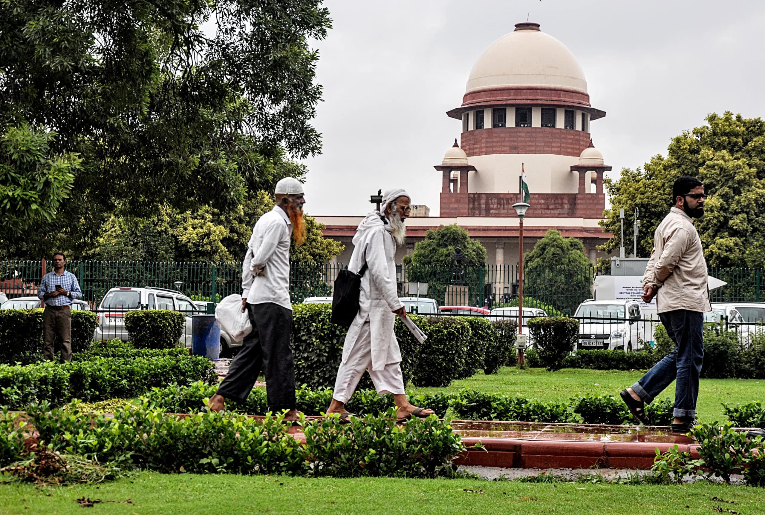 Muslim men walk past at the Supreme Court of India in New Delhi / ANI Photo