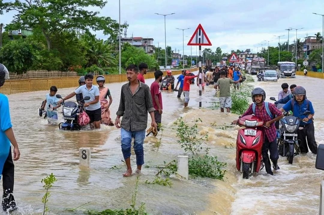 Rescue personnel evacuate residents from a flooded village in Assam as rising waters continue to affect thousands.