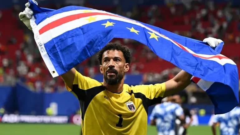 Vozinha waves the Cape Verde flag after their 0-0 draw with Spain at the FIFA World Cup