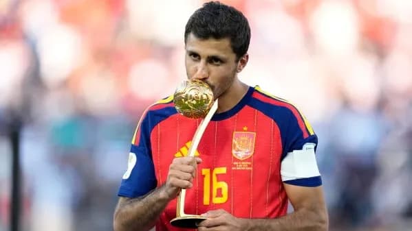 Rodri poses after winning the Golden Ball